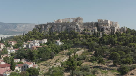 Slow-Aerial-Dolly-towards-Mountain-with-Acropolis-of-Athens-in-Greece-at-Daylight