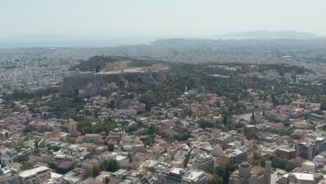 Wide-Establishing-Shot-over-Athens,-Greece-with-Acropolis-and-Ocean-View-in-Summer-Daylight