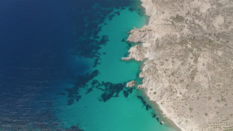 Wide-Aerial-Overhead-Top-Down-View-of-Greek-Island-Coast-in-Milos-in-Summer-with-Turquoise-Blue-Aegean-Sea