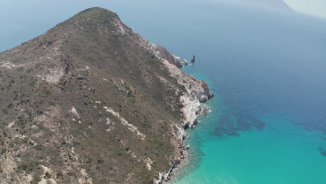 Wide-Aerial-Establishing-Shot-of-Greek-Island-Mountain-on-Milos-in-Summer-with-Turquoise-Blue-Aegean-Sea