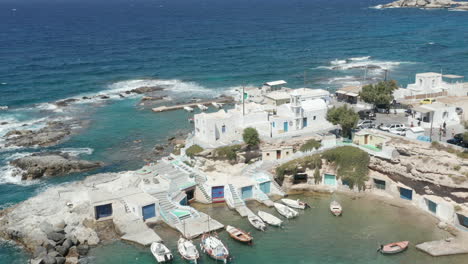 Typical-Greek-Fishing-Village-with-white-Houses-and-waves-crashing
