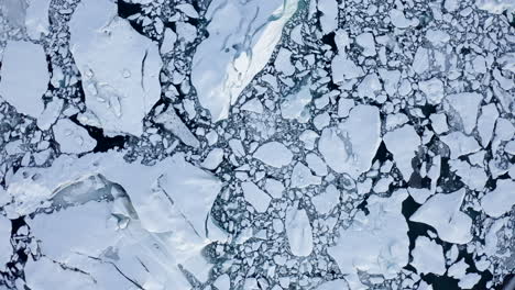 AERIAL:-Birdsview-of-White,-Blue-Snowy-Ice-Floes-on-Iceland-Lake-Winter,-Snow