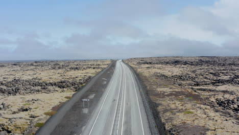 Drone-view-flight-towards-Ring-Road,-highway-route-no.-1-in-Iceland.-Cars-driving-peacefully-on-the-main-road-with-stunning-landscape