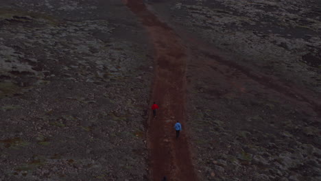 Aerial-view-tourist-hiking-walking-pathway-in-isolated-countryside-in-Iceland.-Drone-view-adventurous-traveler-exploring-icelandic-highlands.-Active-lifestyle