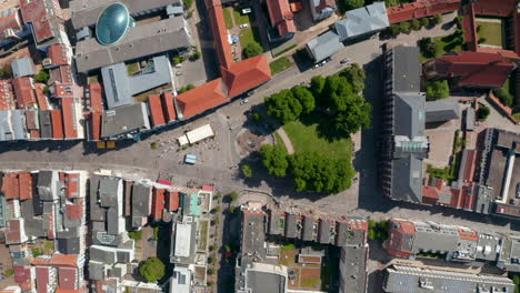 Aerial-birds-eye-overhead-top-down-view-small-square-with-trees-in-city-centre.-Ascending-footage-of-University-square