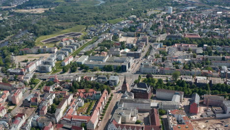 Aerial-panoramic-view-of-town.-Historic-buildings,-gabled-houses-and-newer-buildings-in-distance.-Road-intersection-at-Steintor-town-gate