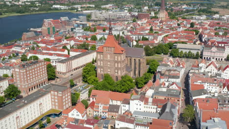 Descending-tilt-up-view-of-town-on-riverside.--Saint-Marys-and--Saint-Peters-churches-towering-over-surrounding-buildings