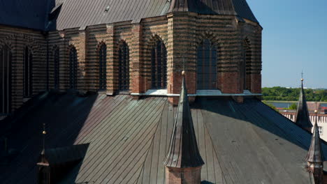 Rising-shot-of-Saint-Marys-church.-Close-up-of-brick-gothic-facade-with-arches,-turrets-and-windows