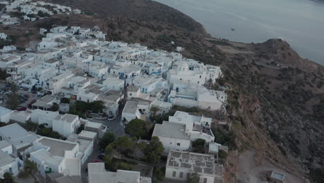 Aerial-view-over-typically-Greek-Village-Small-Town-on-Island-in-Sunset-Golden-Hour-Light