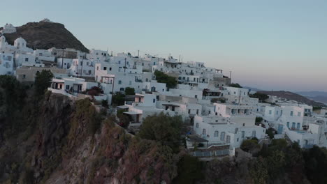 Aerial-perspective-over-typically-Greek-Village-Small-Town-on-Island-in-Sunset-Golden-Hour-Light