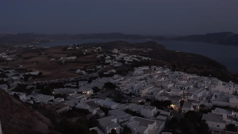 Little-Village-on-a-Mountain-Site-after-Sunset-with-white-Houses,-Aerial-View