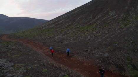 Drone-view-tourist-explorer-walking-trail-in-wild-iceland-highlands.-Aerial-view-four-people-tourist-exploring-rocky-desert-in-icelandic-countryside.-Active-lifestyle.-Wanderlust