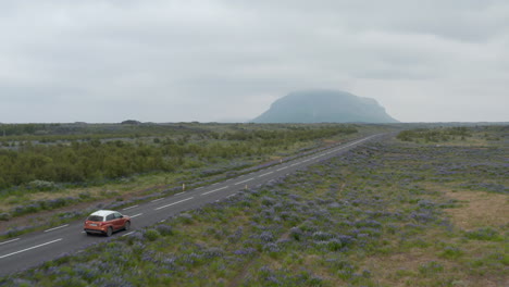 Aerial-view-tracking-car-moving-on-Ring-road-in-Iceland.-Forward-flight-on-breathtaking-and-surreal-icelandic-landscape.-Calm-and-peaceful-roadtrip-of-a-car-through-the-most-important-road-in-Iceland