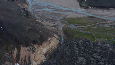 Aerial-view-of-Thorsmork-glacier-valley-with-Krossa-river-flowing-in-Iceland-highlands.-Birds-eye-of-spectacular-river-in-icelandic-countryside-near-glacier-and-volcano