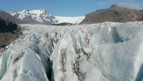 Birds-eye-of-icebergs-of-Icelandic-Breidamerkurjokull-lake-in-Vatnajokull-National-Park.-Climate-change.-Aerial-view-of-glacier-lagoon-with-ice-blocks,-melting-and-cracking-from-the-main-glacier