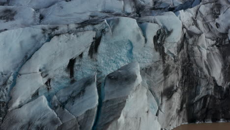 Close-up-drone-view-of-ice-blocks-of-Breidamerkurjokull-glacier-in-Iceland.-Amazing-birds-eye-view-of-glacier-tongue-in-Vatnajokull-national-park.-Global-warming.-Amazing-in-nature