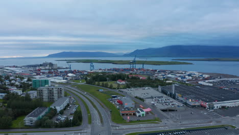 Aerial-view-of-sundahofn,-the-largest-cargo-harbor-in-Iceland,-located-in-Reykjavik.-Drone-view-panoramic-of-icelandic-capital-city-showing-coastal-commercial-trading-port.-Business-concept