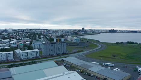 Town-at-sea-bay.-Elevated-footage-of-residential-buildings-and-logistic-or-industrial-site.-Cloudy-day.-Reykjavik,-Iceland