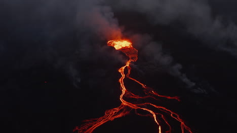 Aerial-view-of-boiling-magmatic-material-in-active-volcano-crater.-Flowing-lava-stream-on-mountain-slope.-Fagradalsfjall-volcano.-Iceland,-2021