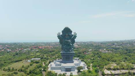 Aerial-dolly-view-of-Garuda-Wisnu-Kencana-statue-in-Bali,-Indonesia.-Forward-dolly-aerial-view-of-large-religious-sculpture-of-Vishnu-riding-Garuda