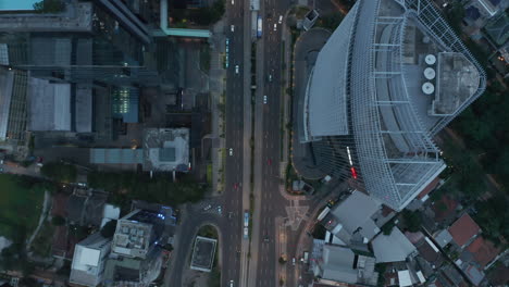 Aerial-Birds-Eye-Overhead-Top-Down-View-of-busy-city-traffic-and-public-transportation-on-a-busy-multi-lane-road-at-dusk