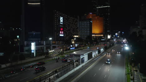 Aerial-cinematic-rising-shot-of-busy-multi-lane-highway-traffic-at-night-from-street-view-to-aerial-view-of-busy-traffic-in-Jakarta