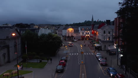 Descending-footage-of-street-in-evening-town.-Road-with-crosswalk-and-flashing-warn-lights.-Killarney,-Ireland-in-2021