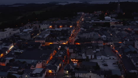 Aerial-panoramic-shot-of-evening-town.-Colour-illuminated-streets-and-town-development.-Killarney,-Ireland