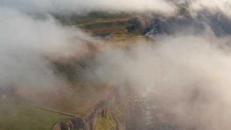 Aerial-footage-of-beautiful-and-high-rocky-cliffs-on-sea-coast.-Low-clouds-flying-away-and-revealing-breath-taking-scenery.-Cliffs-of-Moher,-Ireland