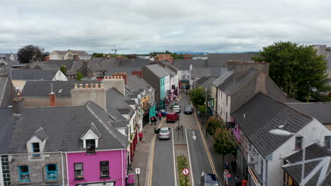 Forwards-fly-above-narrowing-street-in-town-centre.-Shops-and-services-in-houses-along-street.-Ennis,-Ireland