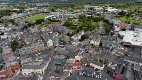 Aerial-descending-shot-of-buildings-in-city-centre.-Houses-along-narrow-streets-and-squares.-Ennis,-Ireland