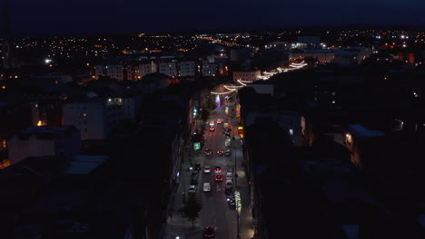 Fly-above-night-city.-Cars-driving-in-streets-of-urban-neighbourhood.-Light-decoration.-Limerick,-Ireland