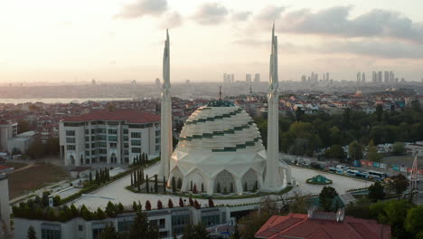 Futuristic-Mosque-Empty-in-Istanbul,-Modern-looking-Temple-at-Sunset-with-Cityscape,-Slow-Aerial-forwards