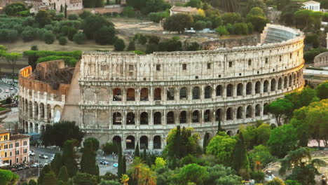 Zoomed-slide-and-pan-footage-of-ancient-Colosseum-amphitheatre-in-evening-sun.-Historic-tourist-landmark.-Rome,-Italy