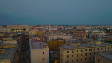 Low-flight-above-rooftops-of-buildings-in-urban-borough-at-twilight.-Various-residential-houses-in-city.-Rome,-Italy