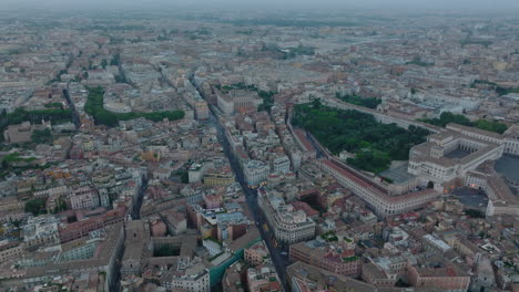 Aerial-panoramic-shot-of-large-palaces-and-other-tourist-landmarks-in-historic-city-centre-at-dusk.-Rome,-Italy