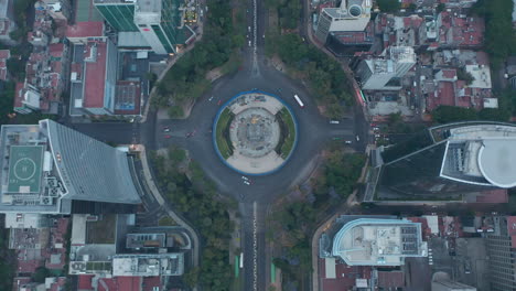 Overhead-top-down-aerial-view-of-roundabout-around-The-Angel-of-Independence-monument-in-urban-city-center-of-Mexico-City
