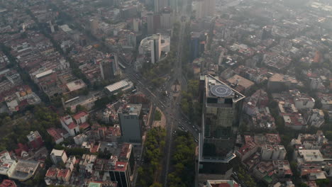 Aerial-view-of-heavy-traffic-in-city-streets.-Forwards-fly-and-tilt-down-shot-of-several-crossroads-in-downtown.-Mexico-City,-Mexico.