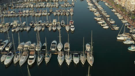 Sailboats-in-the-Harbour-of-small-town-on-Malta-Island,-Aerial-tilt-down-view