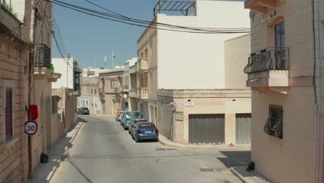Small-mediterranean-Town-Empty-Street-because-of-Coronavirus-Covid-19-Pandemic-and-Lockdown,-Aerial-dolly-forward-between-Beige-and-Sand-Colored-Houses