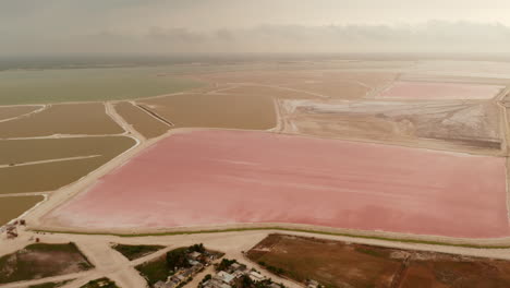 Aerial-footage-of-colourful-lakes-at-seashore.-Huge-salt-evaporation-ponds-for-sea-salt-extraction.-Las-Coloradas,-Yucatan,-Mexico