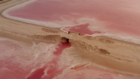 Aerial-view-of-culvert-between-two-pink-lakes.-Strange-colour-of-water-coloured-by-specific-microorganisms.-Las-Coloradas,-Yucatan,-Mexico