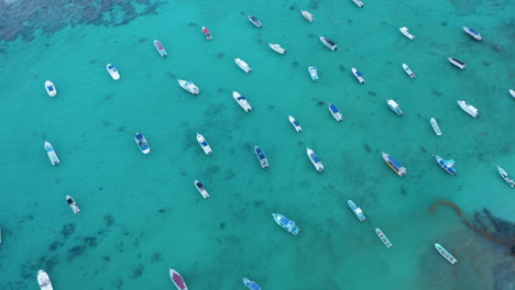 Top-down-view-with-boats-moored-in-the-turquoise-water