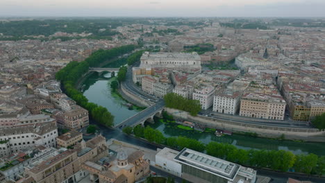 Aerial-panoramic-view-of-Tiber-river-bend-in-historic-city-centre.-Old-city-with-ancient-tourist-landmarks.-Rome,-Italy