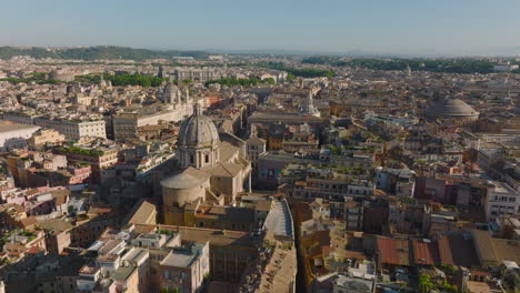 Aerial-view-of-historic-tourist-sights-in-city-centre.-Towers-and-domes-of-churches-and-basilicas,-buildings-lit-by-sunshine.-Rome,-Italy