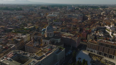 San-Carlo-al-Corso-and-surrounding-buildings-in-city-centre.-Aerial-footage-of-basilica-with-dome.-Rome,-Italy