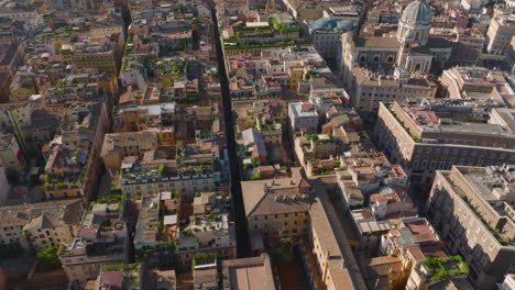 High-angle-view-of-rooftop-terraces-with-green-plants.-Tilt-up-revealing-panoramic-view-of-historic-urban-borough-with-famous-landmarks.-Rome,-Italy