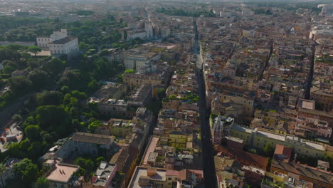 Forwards-fly-above-streets-and-buildings-in-city.-Sights-in-historic-urban-borough.-Scene-lit-by-morning-sun.-Rome,-Italy