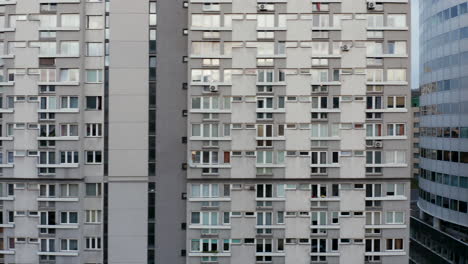 Sliding-reveal-of-large-apartment-building-on-housing-estate.-Full-frame-of-wall-with-windows.-Warsaw,-Poland