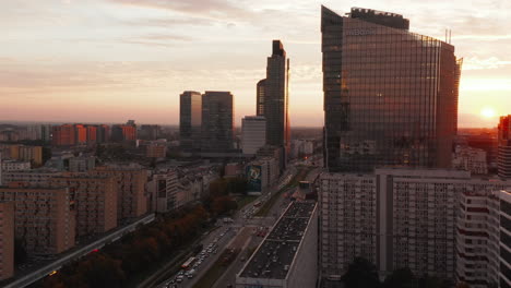 Slide-and-pan-footage-of-modern-high-rise-buildings-with-glossy-facades-reflecting-setting-sun.--Warsaw,-Poland